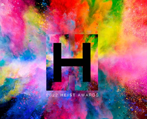 Colorful explosion with a large black "H" in the center, labeled "2022 Heist Awards" against a vibrant multicolored abstract background.