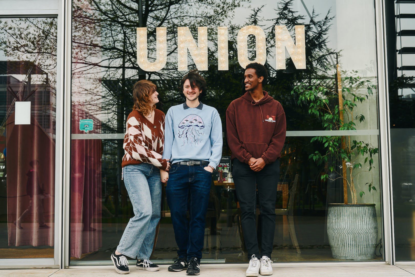 A group stands outside a building.