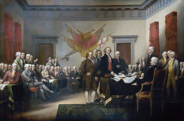 The image depicts a historical painting of several people in 18th-century attire gathered in a room, with some presenting a document to a seated figure.
