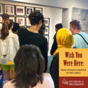 A group of people viewing an art exhibition titled "Wish You Were Here: From Horace Walpole to Ted Lasso" at the Museum of Richmond.