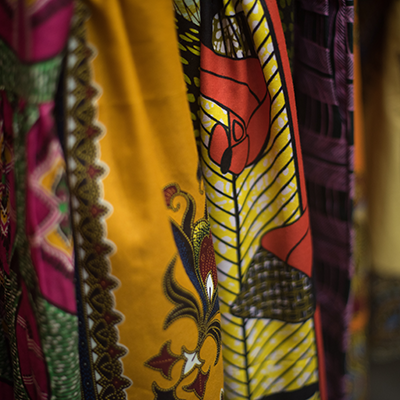 A collection of colorful patterned fabrics with intricate designs and vibrant hues, showcasing traditional and artistic textile craftsmanship.