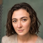 A close up image of a person with dark brown hair and brown eyes