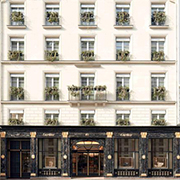 Sup-de-Luxe A stylish, multi-story Parisian building with ornate windows and a grand entrance, featuring decorative greenery on each balcony. Urban setting, no people visible.