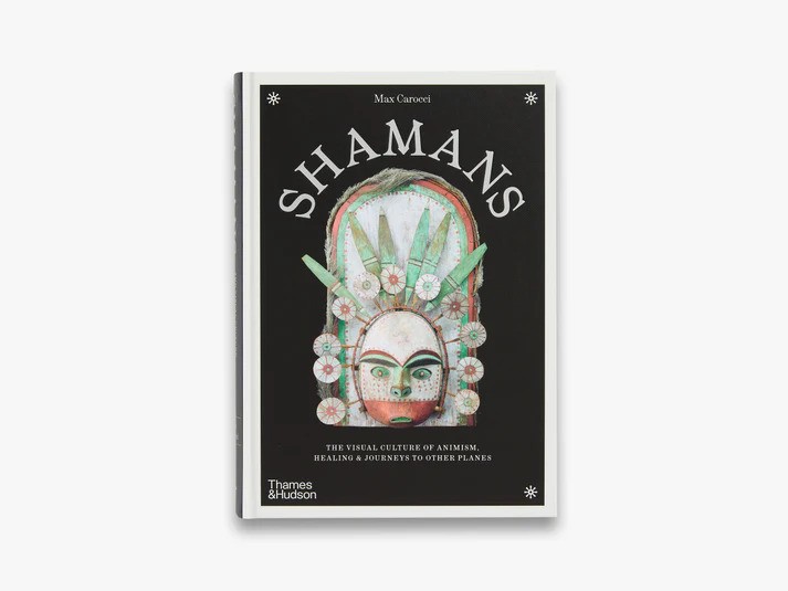 The image shows the book cover for "Shamans" by Max Carocci, featuring an intricate mask design against a black background.