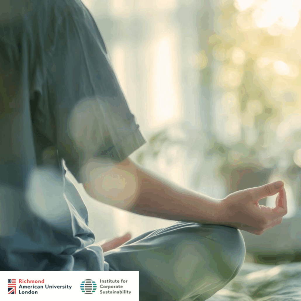 A person sits in a meditation posture indoors, hand poised in a mudra, amidst soft natural lighting. Richmond American University London logo visible.