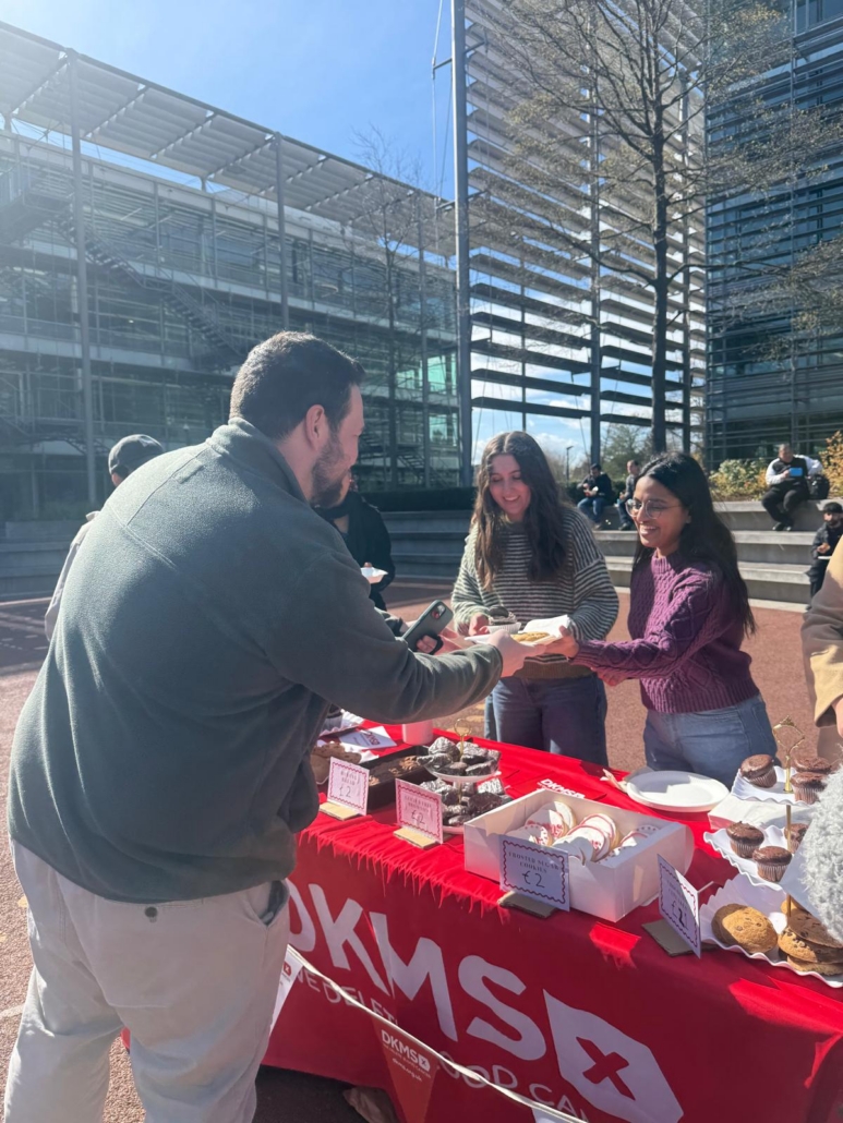 Service Learning students at Chiswick Park Plaza with the DKMS baking against cancer initiative community engagement community buying the baked goods