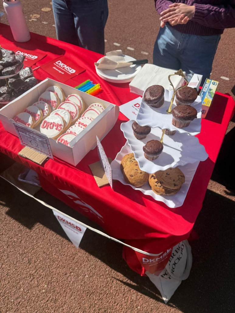 Service Learning students at Chiswick Park Plaza with the DKMS baking against cancer initiative community engagement baked goods