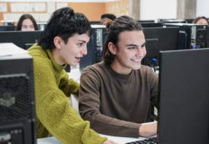 Young diverse students doing research at school inside computer